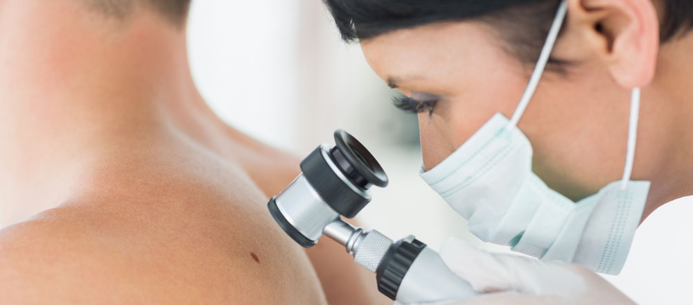 A dermatologist checking a patient's skin